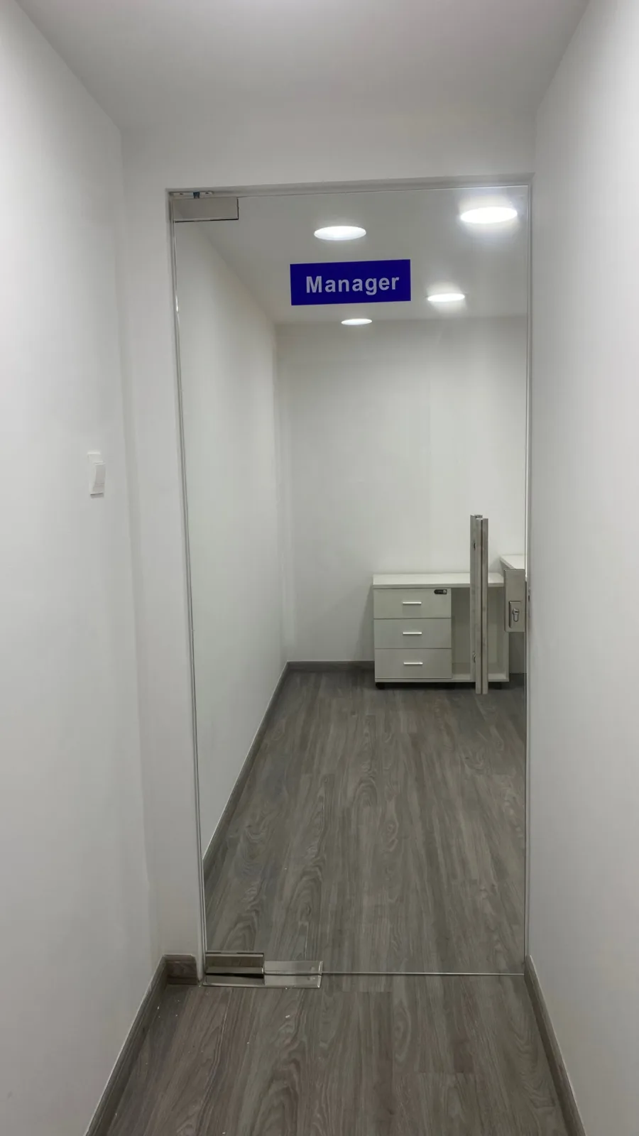 Manager office wayfinding in the internal corridor.