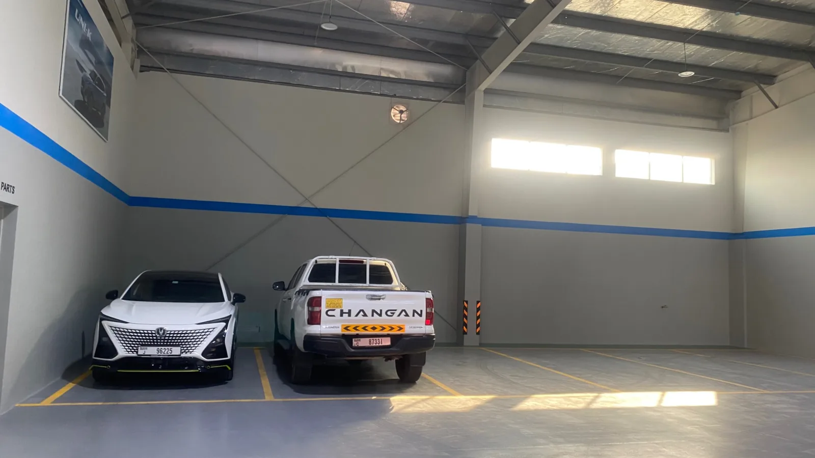 Vehicle bays within the completed facility environment.