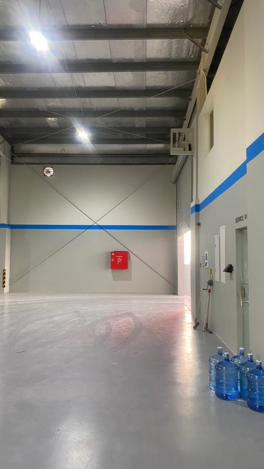 Blue wall band running through the workshop interior.