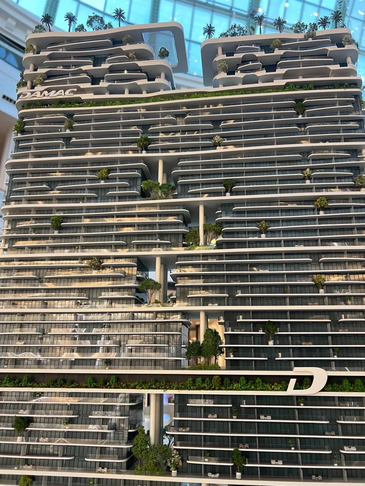 Close-up of balconies and greenery on a DAMAC model tower.
