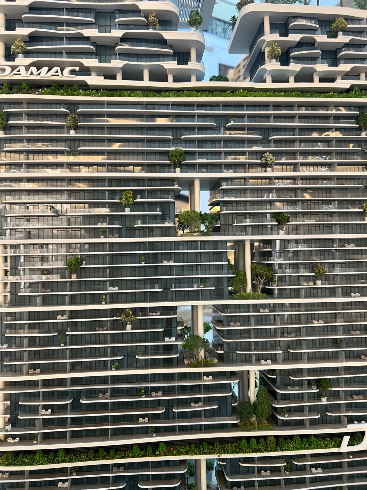 Close view of horizontal balcony lines and planting on the DAMAC model.