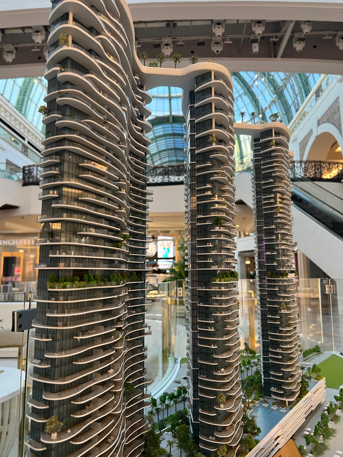 Two model towers with curved balcony lines and connecting landscape details.